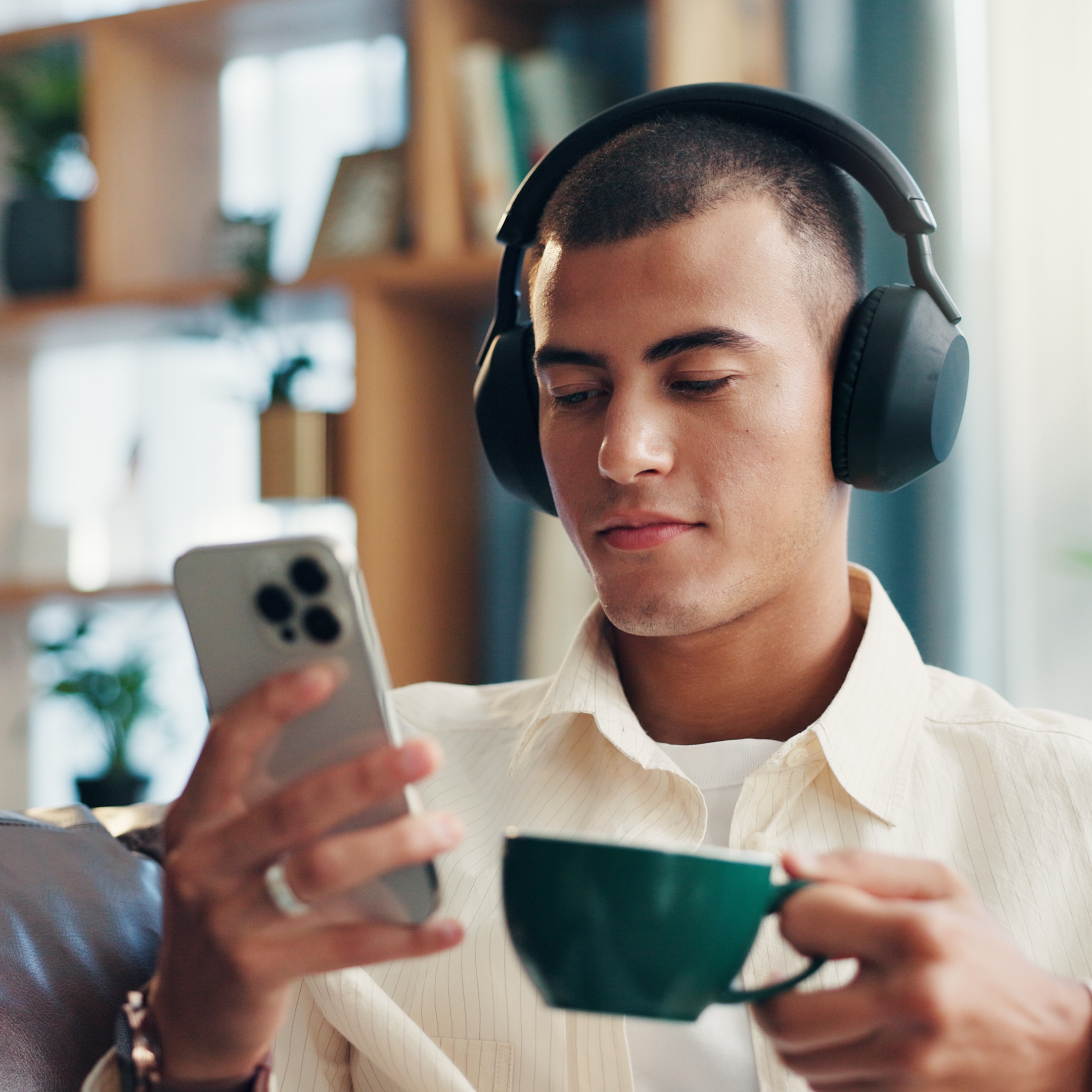 home-man-coffee-with-mobile-music-wellness-comfortable-sofa-morning-house-male-person-relax-with-headphones-listening-sound-espresso-smartphone-app-audio-track copy